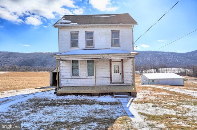 front facade featuring a mountain view and covered porch