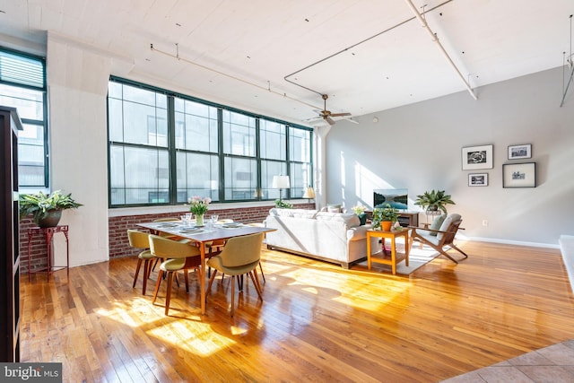 dining room featuring a healthy amount of sunlight, hardwood / wood-style floors, and ceiling fan