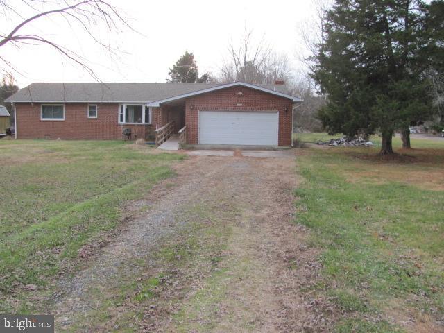 single story home with a garage and a front yard