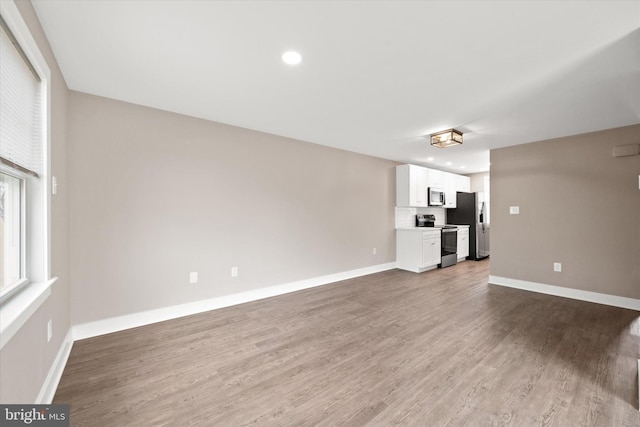 unfurnished living room with wood-type flooring