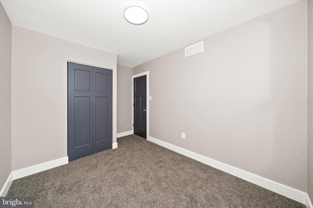 unfurnished bedroom with carpet floors and a closet