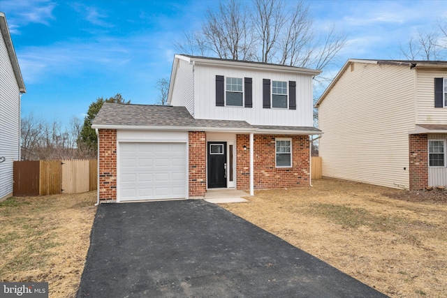 view of front property featuring a garage and a front lawn