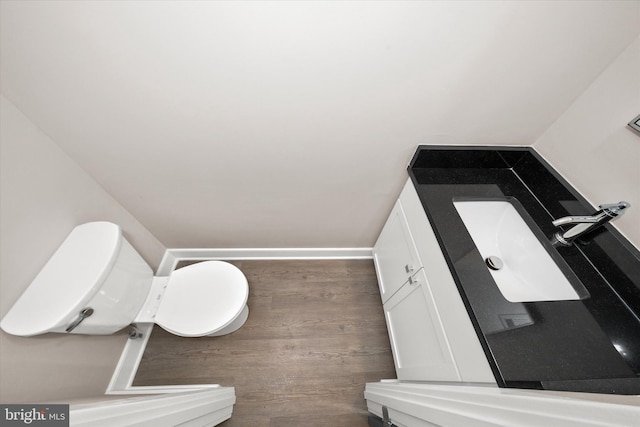 bathroom featuring wood-type flooring and toilet