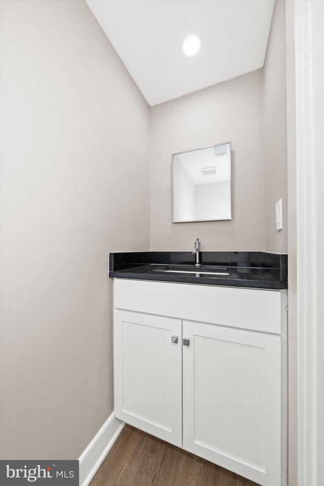 bathroom featuring vanity and hardwood / wood-style floors