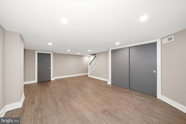 basement with light hardwood / wood-style flooring