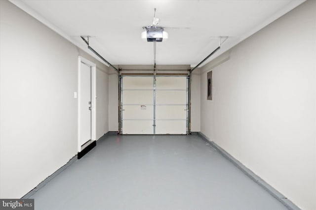 garage with a garage door opener and electric panel