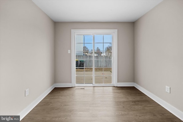 unfurnished room featuring dark hardwood / wood-style flooring