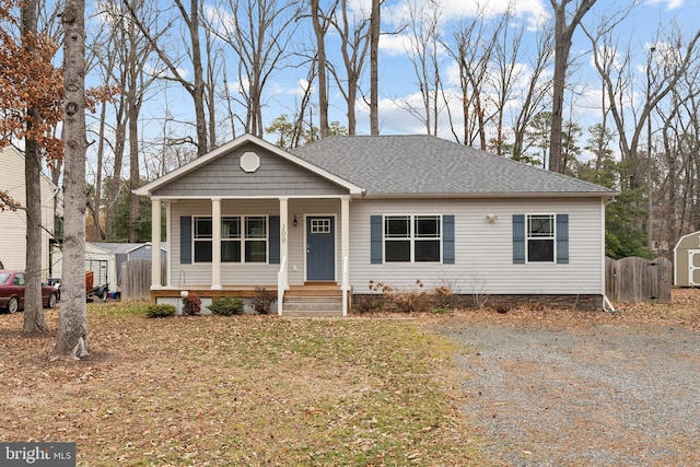 view of front of property with covered porch and a storage shed