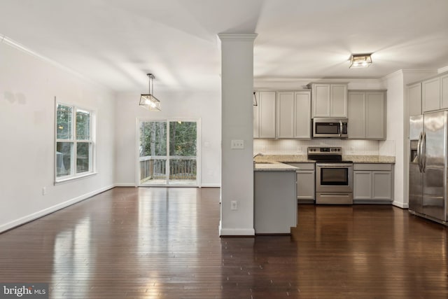 kitchen featuring light stone counters, hanging light fixtures, appliances with stainless steel finishes, gray cabinets, and decorative backsplash