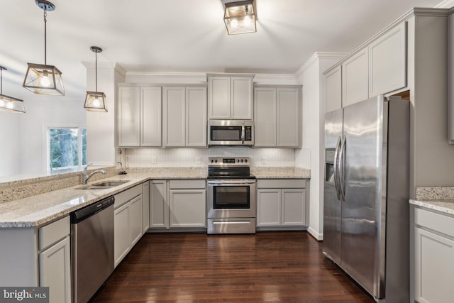 kitchen featuring pendant lighting, sink, gray cabinetry, stainless steel appliances, and light stone countertops