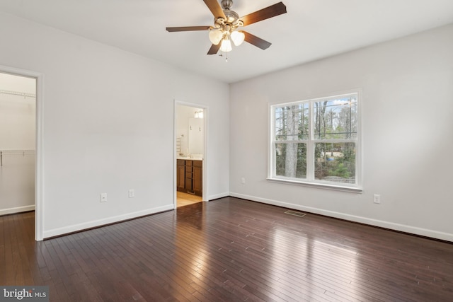 unfurnished room with dark hardwood / wood-style floors and ceiling fan