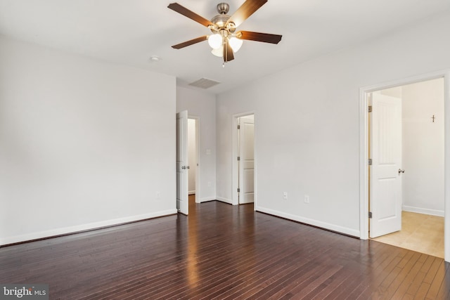 empty room with dark hardwood / wood-style floors and ceiling fan