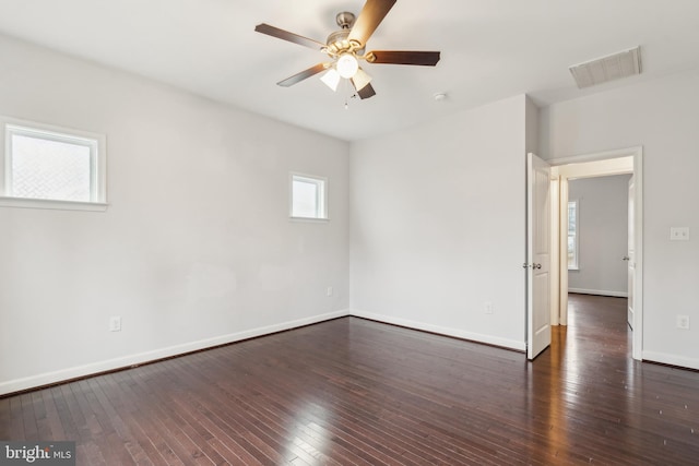 spare room featuring dark wood-type flooring and ceiling fan