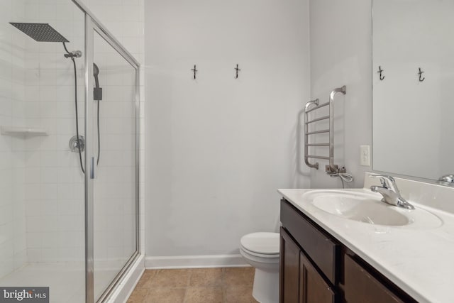 bathroom featuring vanity, an enclosed shower, and toilet