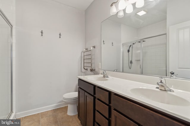 bathroom featuring vanity, toilet, an enclosed shower, and tile patterned flooring