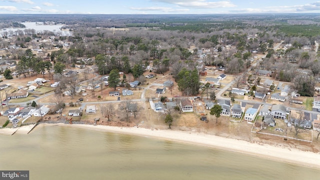 birds eye view of property with a water view and a beach view