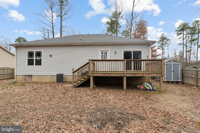 rear view of property featuring cooling unit, a storage shed, and a deck