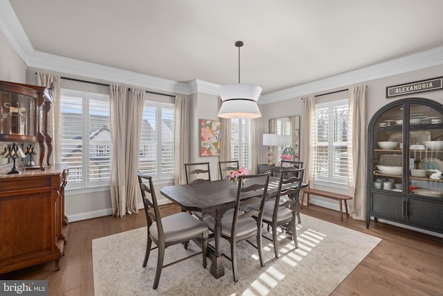 dining space featuring crown molding and hardwood / wood-style floors