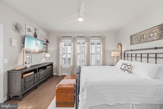 bedroom with wood-type flooring and ceiling fan