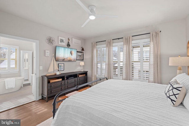 bedroom featuring multiple windows, hardwood / wood-style flooring, and ceiling fan