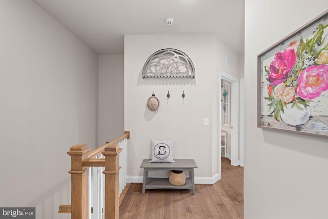 hallway with light hardwood / wood-style floors