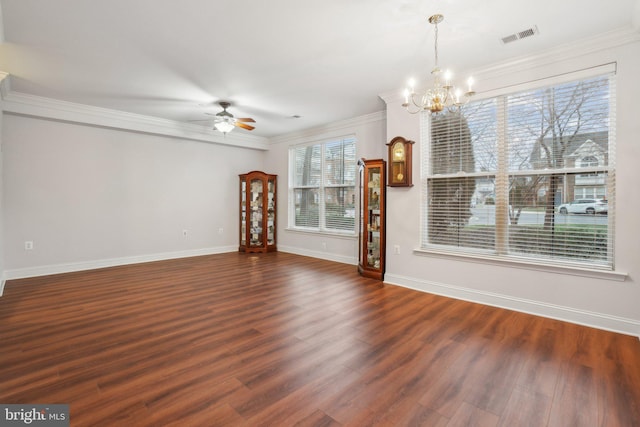 unfurnished living room featuring ceiling fan with notable chandelier, dark wood-type flooring, and ornamental molding