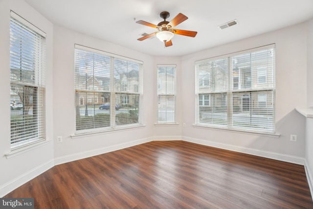 unfurnished sunroom featuring ceiling fan