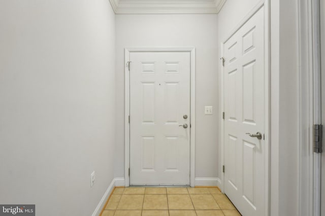 doorway with crown molding and light tile patterned floors