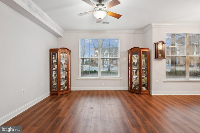 unfurnished dining area with crown molding, dark wood-type flooring, and ceiling fan