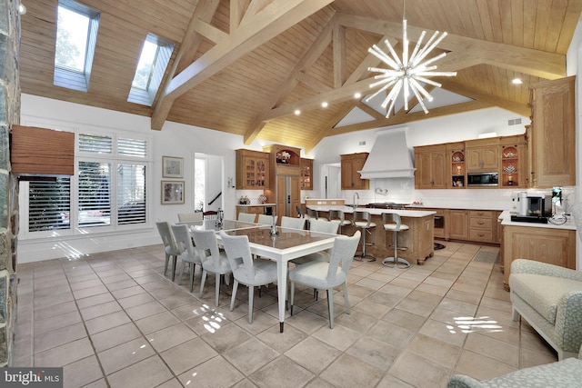 dining space with beam ceiling, light tile patterned floors, an inviting chandelier, wood ceiling, and high vaulted ceiling