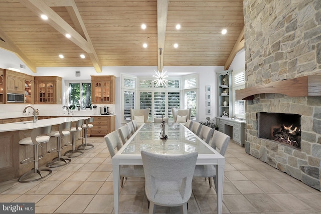 dining space featuring beam ceiling, wooden ceiling, and light tile patterned floors