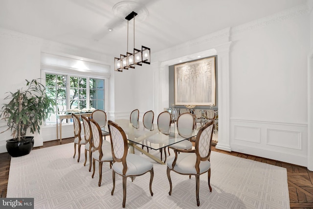 dining room with a wainscoted wall and a decorative wall