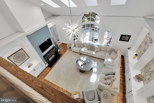 living room with a skylight and an inviting chandelier