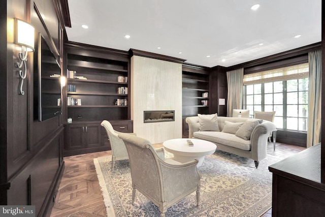 living area featuring recessed lighting, a fireplace, built in features, and crown molding