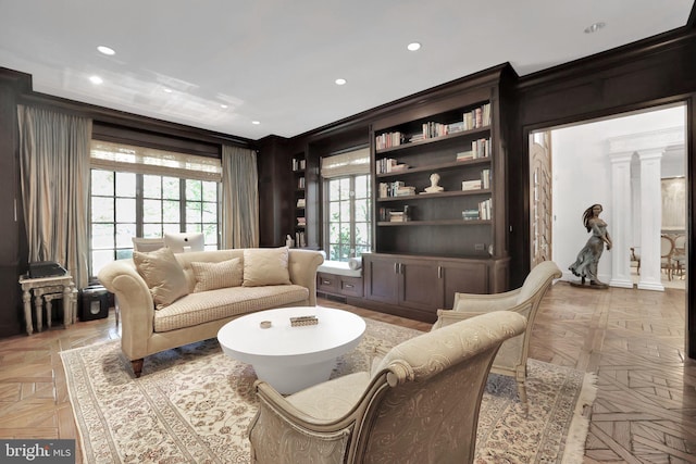 living area featuring recessed lighting and decorative columns