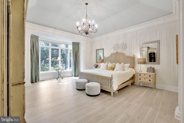 bedroom with light wood-style floors, a raised ceiling, ornamental molding, and baseboards