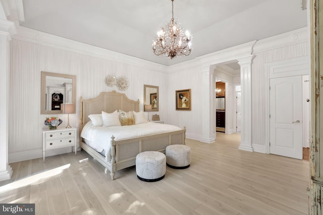 bedroom with decorative columns, light wood-style flooring, baseboards, and wallpapered walls