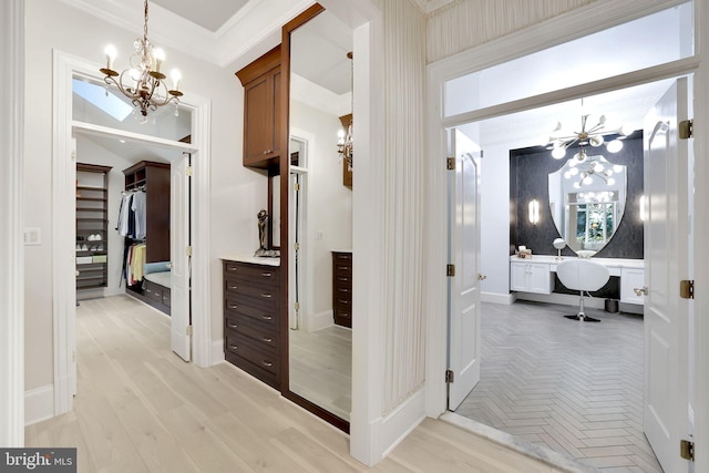 corridor with a chandelier, parquet floors, crown molding, and baseboards