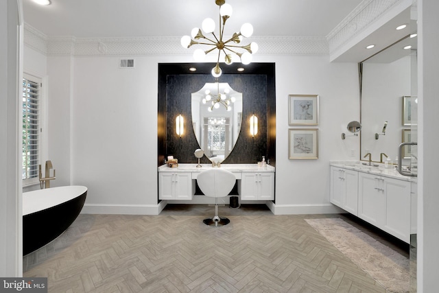 bathroom with baseboards, two vanities, a notable chandelier, crown molding, and a sink