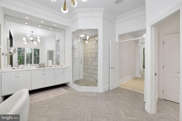 bathroom with double vanity, crown molding, a shower stall, and an inviting chandelier