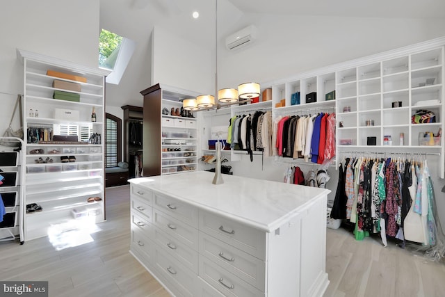 walk in closet featuring an AC wall unit, high vaulted ceiling, and light wood-style flooring