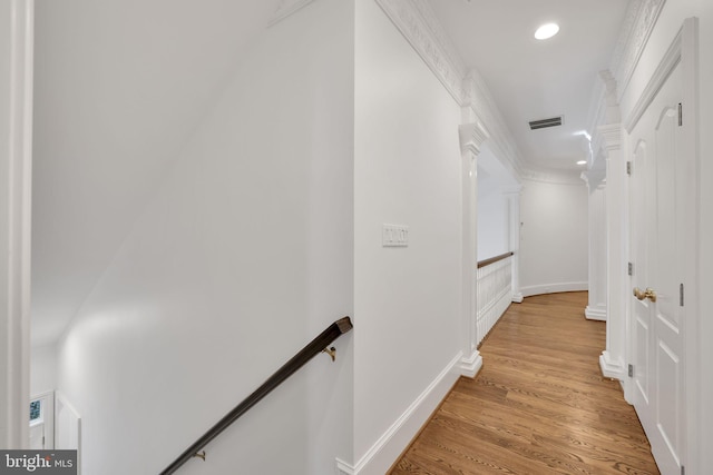 corridor featuring light wood finished floors, baseboards, visible vents, an upstairs landing, and recessed lighting