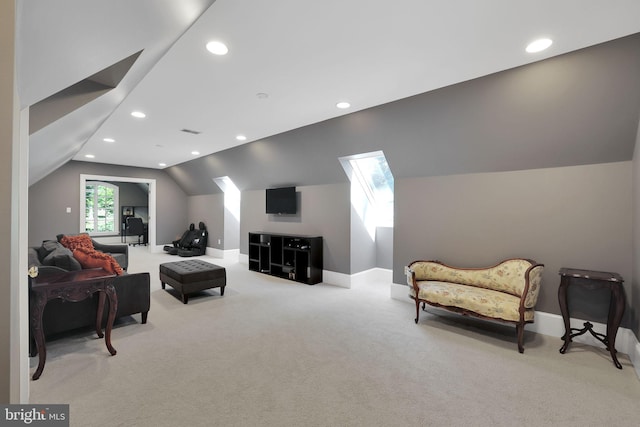 living room featuring recessed lighting, light colored carpet, visible vents, lofted ceiling with skylight, and baseboards