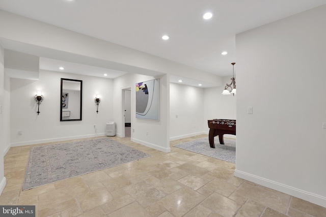 playroom with stone finish floor, baseboards, and recessed lighting