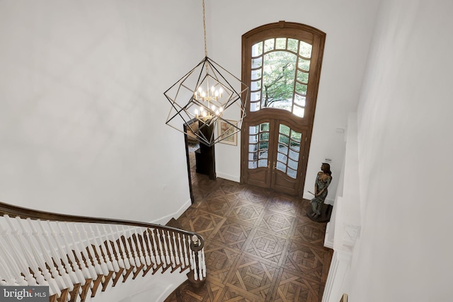 entrance foyer featuring stairs, dark tile patterned flooring, french doors, and baseboards