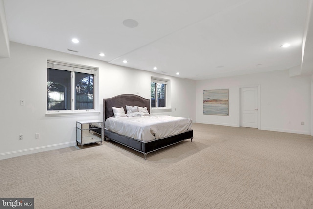 bedroom with baseboards, recessed lighting, visible vents, and light colored carpet