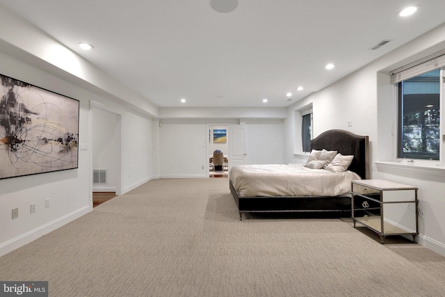 bedroom featuring light carpet, baseboards, visible vents, and recessed lighting