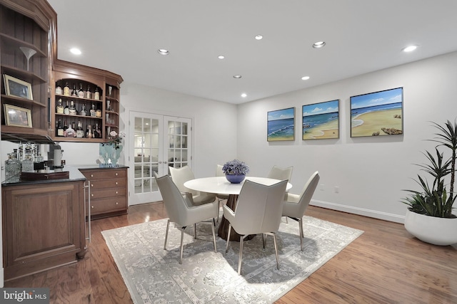 dining room with recessed lighting, french doors, baseboards, and wood finished floors