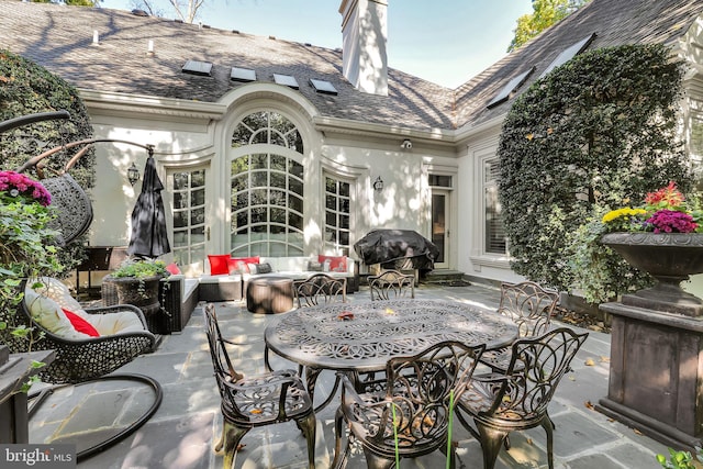 view of patio with an outdoor hangout area, french doors, outdoor dining area, and grilling area