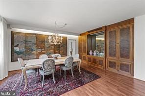 dining room with an inviting chandelier and wood-type flooring